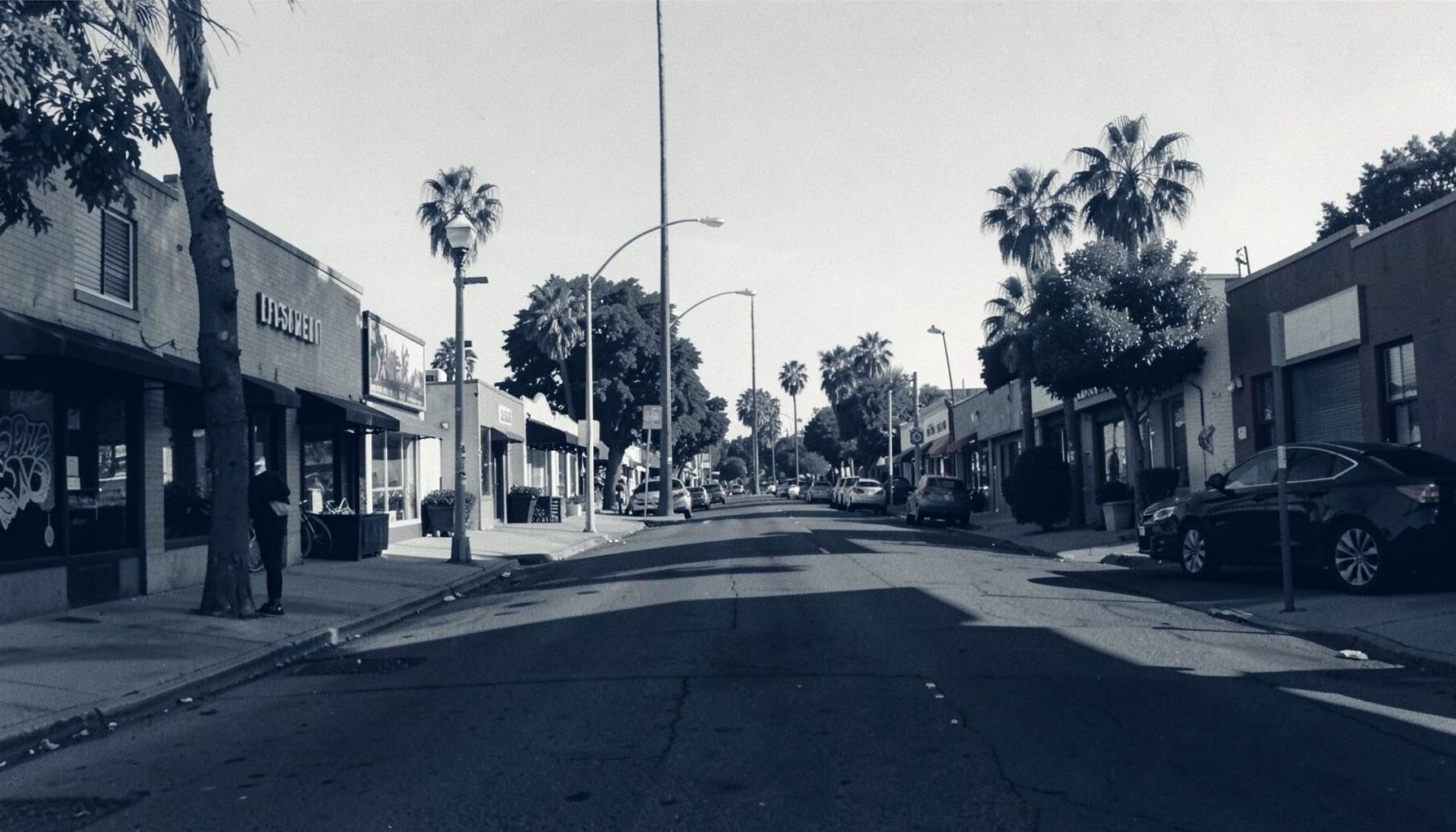 A street-level view of a North Park San Diego neighborhood in soft afternoon light with muted urban tones, duotone photograph